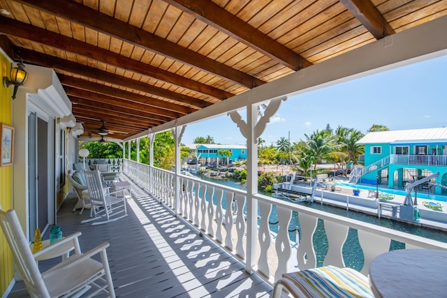 view of patio / terrace with a ceiling fan and a water view