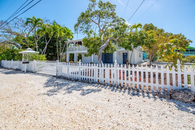 view of front of property with a fenced front yard and a balcony