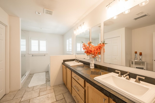 bathroom with vanity and shower with separate bathtub