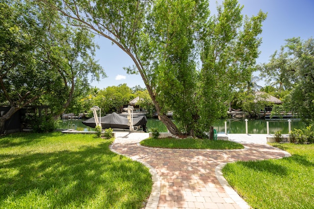 view of yard with a dock and a water view