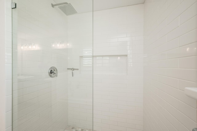 bathroom with tiled shower