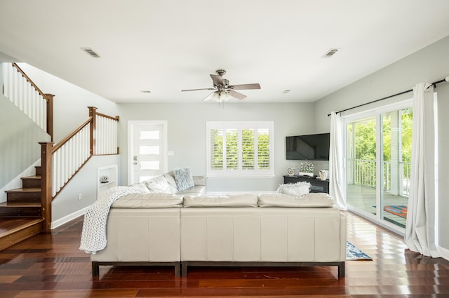 living room with ceiling fan, a healthy amount of sunlight, and dark hardwood / wood-style floors