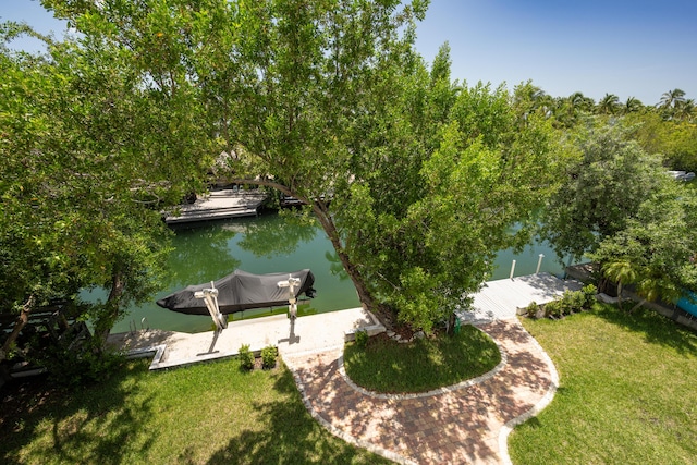 dock area with a water view and a lawn