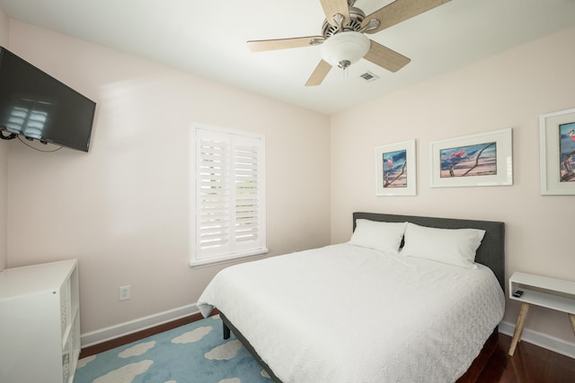 bedroom with dark hardwood / wood-style floors and ceiling fan