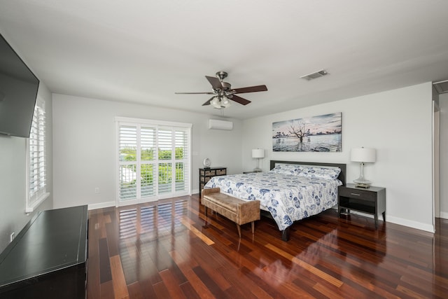 bedroom with ceiling fan, dark hardwood / wood-style floors, a wall mounted AC, and access to exterior