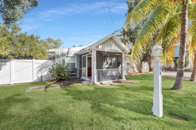 rear view of property with a yard and covered porch