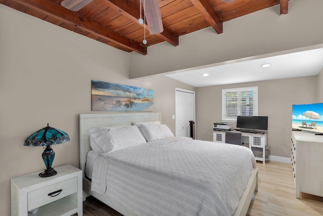 bedroom featuring wood ceiling, beam ceiling, a closet, and light wood-type flooring