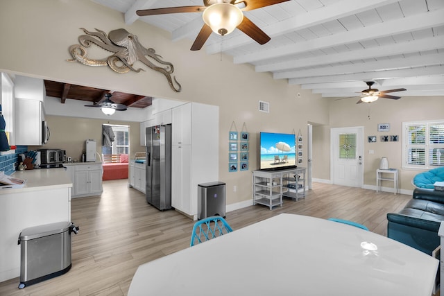 living room with vaulted ceiling with beams, ceiling fan, wood ceiling, and light wood-type flooring