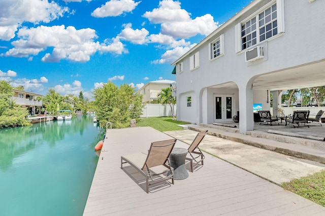 dock area featuring a water view and a wall mounted air conditioner