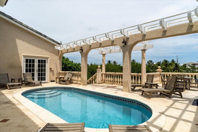 view of swimming pool featuring a pergola and a patio area