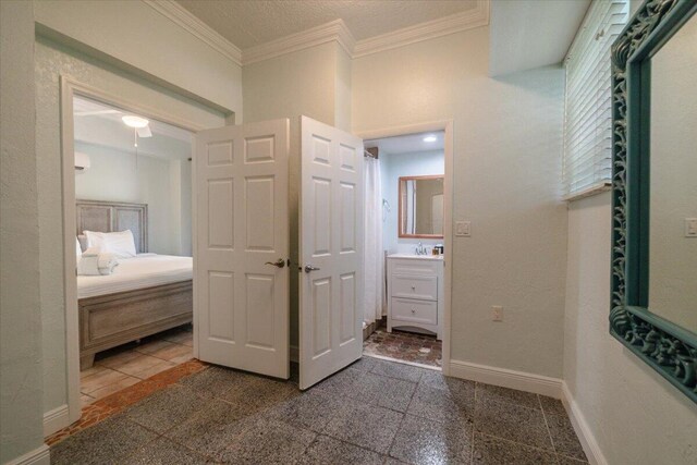 bathroom with ornamental molding and vanity