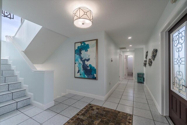 entrance foyer with light tile patterned floors