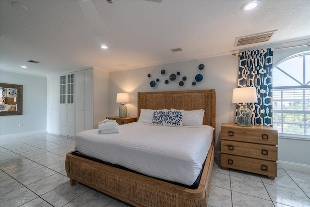 bedroom with ornamental molding and a textured ceiling