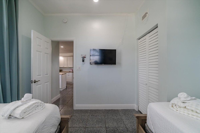 bedroom with crown molding and a closet