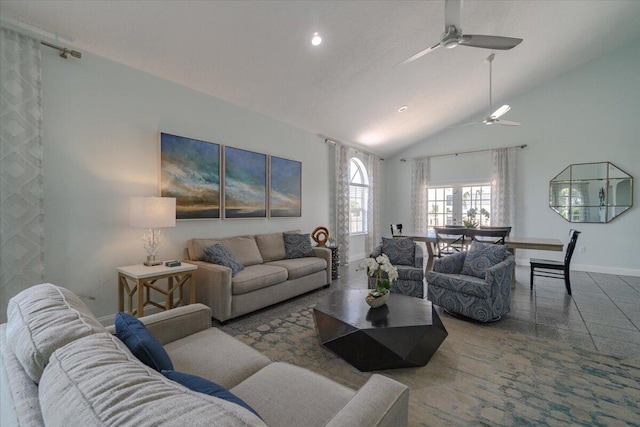 living room with ceiling fan and high vaulted ceiling