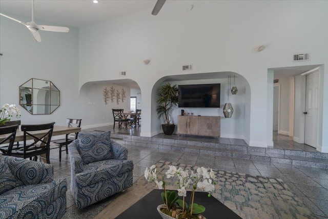 living room featuring ceiling fan and high vaulted ceiling