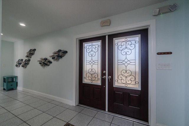 entryway featuring light tile patterned floors and french doors