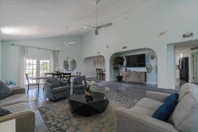 living room featuring high vaulted ceiling and ceiling fan