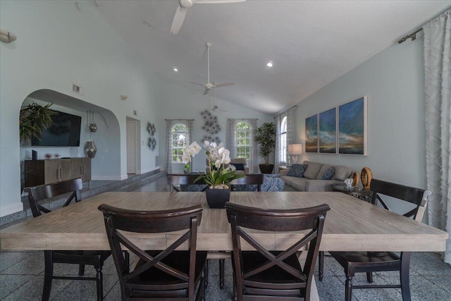 dining space featuring ceiling fan and high vaulted ceiling