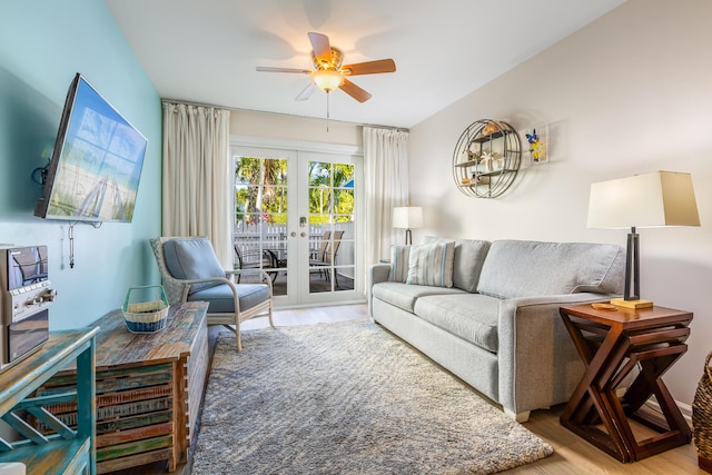 living room with french doors, ceiling fan, and hardwood / wood-style flooring