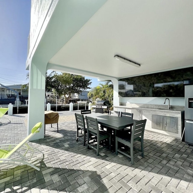 view of patio featuring area for grilling and sink