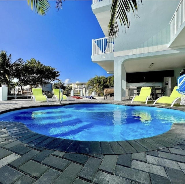 view of swimming pool with a patio