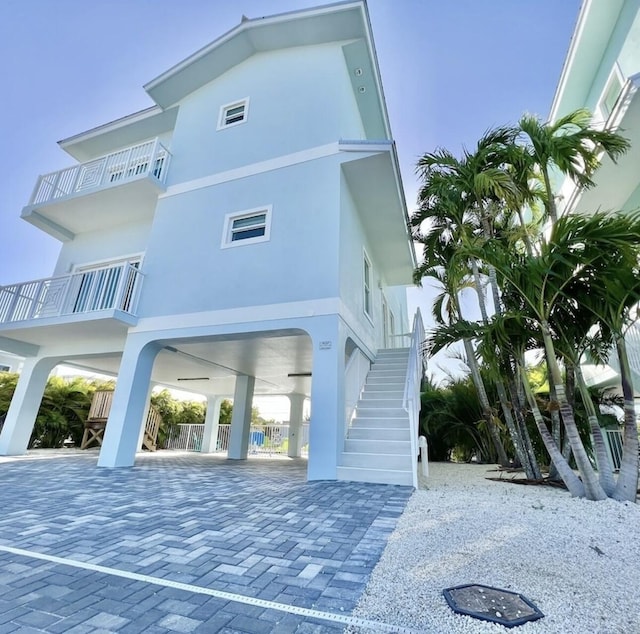 exterior space with a carport and a balcony