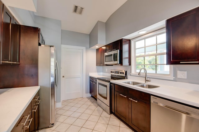 kitchen featuring sink, light tile patterned flooring, and appliances with stainless steel finishes