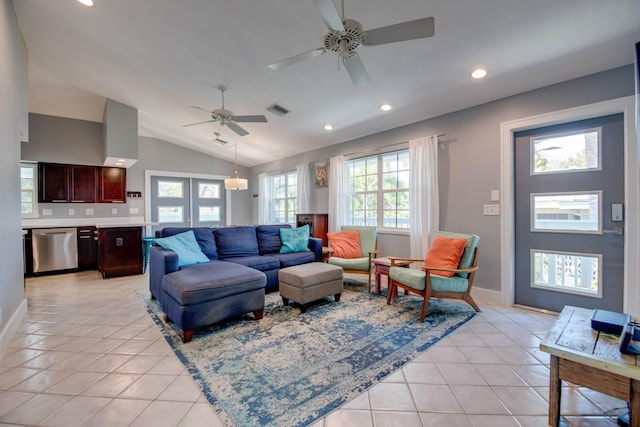 living room featuring lofted ceiling, light tile patterned floors, and ceiling fan