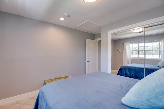 bedroom with light tile patterned flooring and a closet