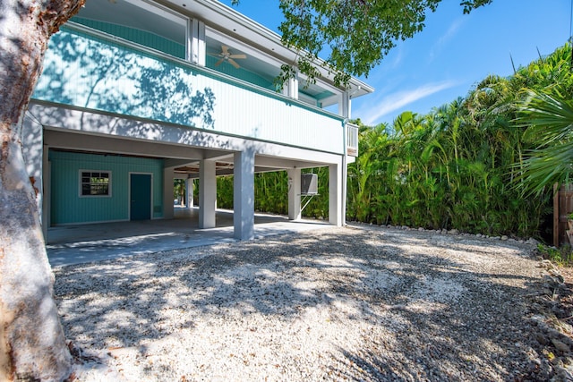 exterior space featuring a carport and ceiling fan