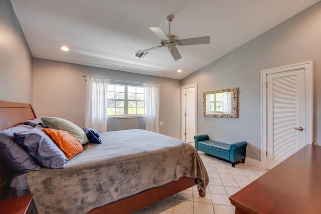 bedroom with lofted ceiling, light tile patterned floors, and ceiling fan