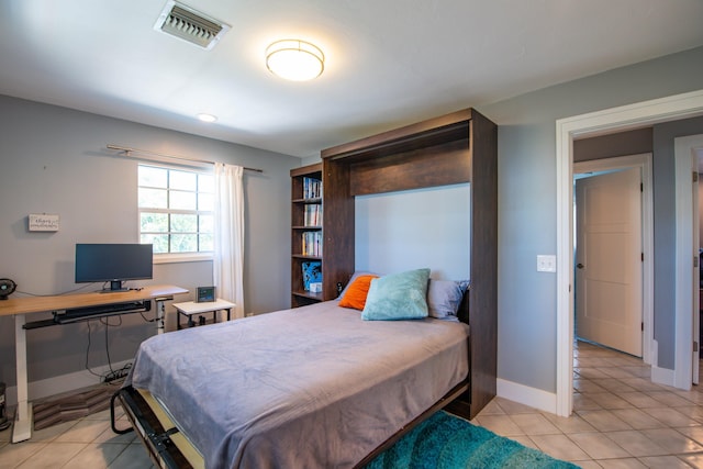 bedroom with light tile patterned floors