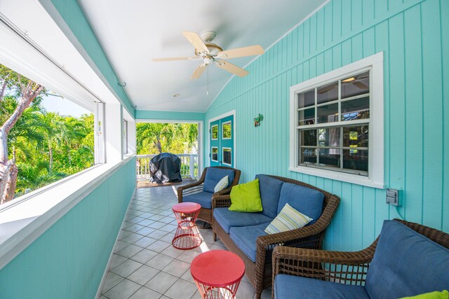 sunroom / solarium with lofted ceiling and ceiling fan