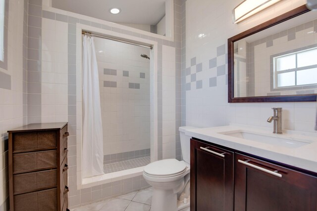 bathroom with tile walls, tile patterned flooring, vanity, a shower with curtain, and toilet