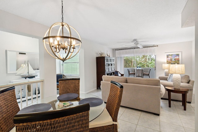 tiled dining room featuring ceiling fan with notable chandelier