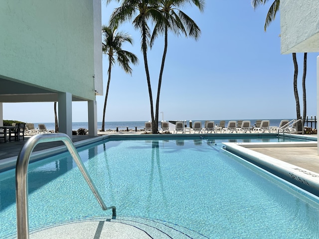 view of pool with a water view