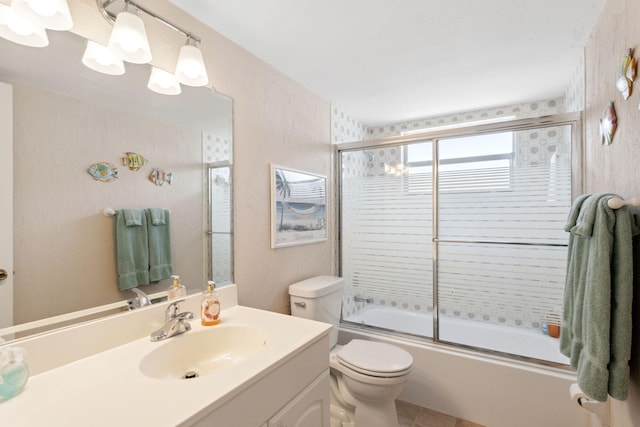 full bathroom with vanity, combined bath / shower with glass door, and toilet