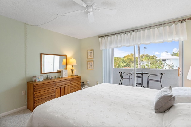 bedroom with ceiling fan, carpet flooring, access to exterior, and a textured ceiling