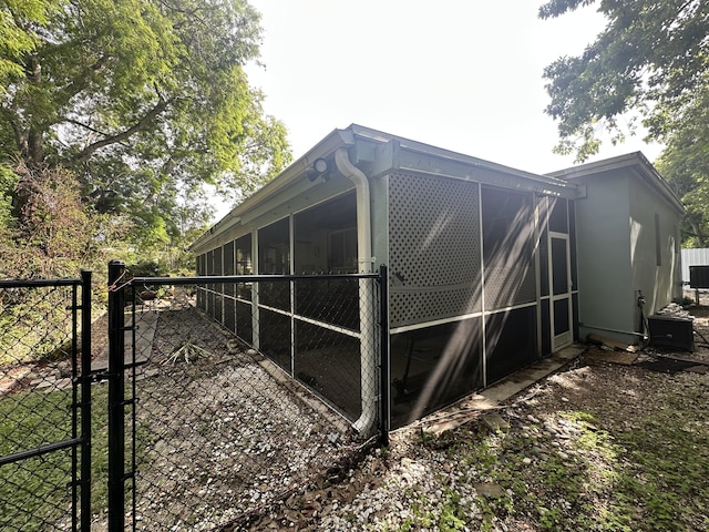 349 Mahogany Dr, Key Largo, FL 33037 - view of home's exterior featuring a gate and a sunroom