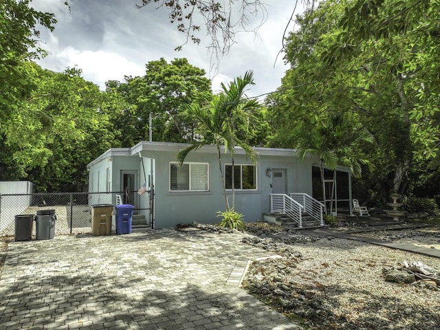 349 Mahogany Dr, Key Largo, FL 33037 - view of front of home featuring stucco siding and a gate