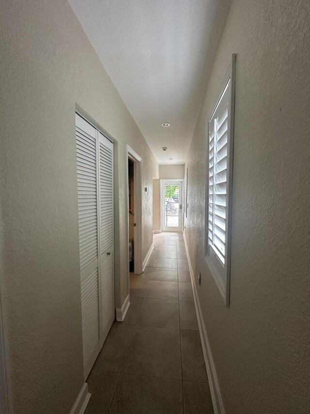 349 Mahogany Dr, Key Largo, FL 33037 - hallway featuring tile patterned floors and a textured wall
