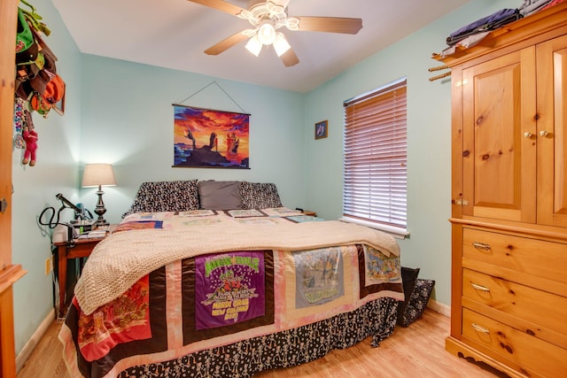 bedroom with baseboards, ceiling fan, and light wood finished floors