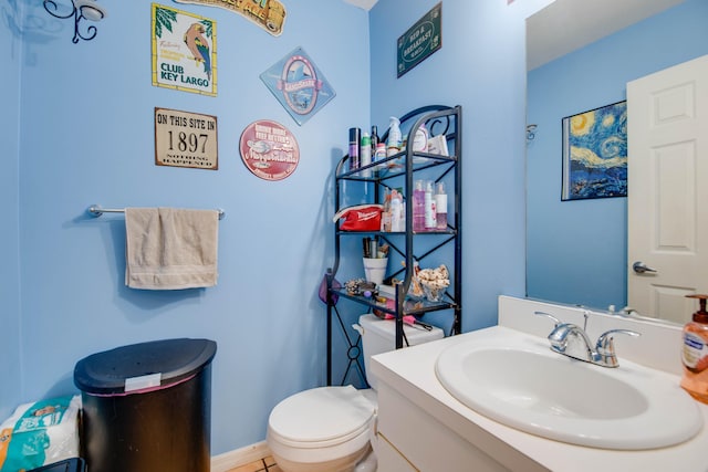 bathroom featuring toilet and vanity