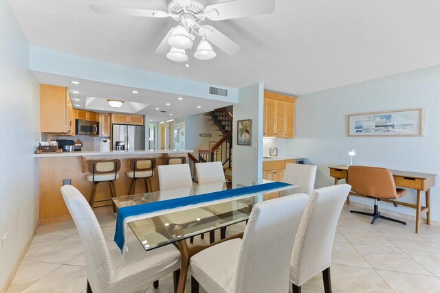 tiled dining room featuring ceiling fan