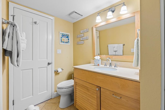 bathroom with vanity, toilet, and tile patterned flooring