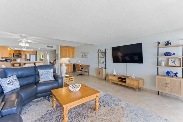 living room with light tile patterned floors and ceiling fan