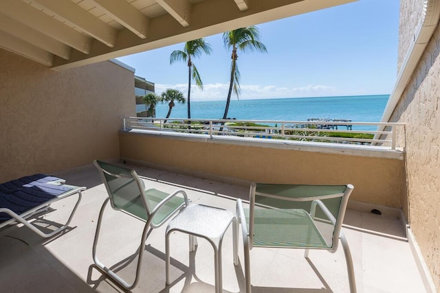 balcony featuring a water view