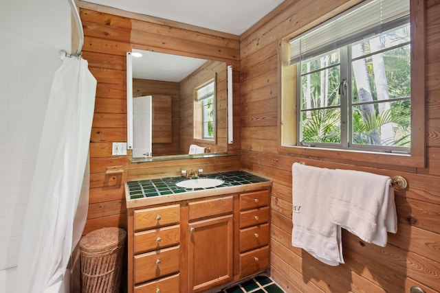 bathroom featuring wooden walls and vanity