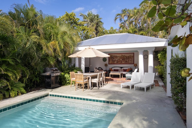 outdoor pool with an outdoor structure, a grill, outdoor lounge area, and a patio